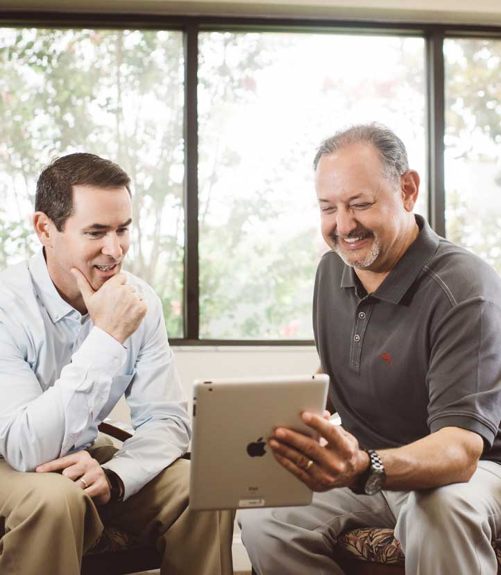 Dentist showing patient ipad